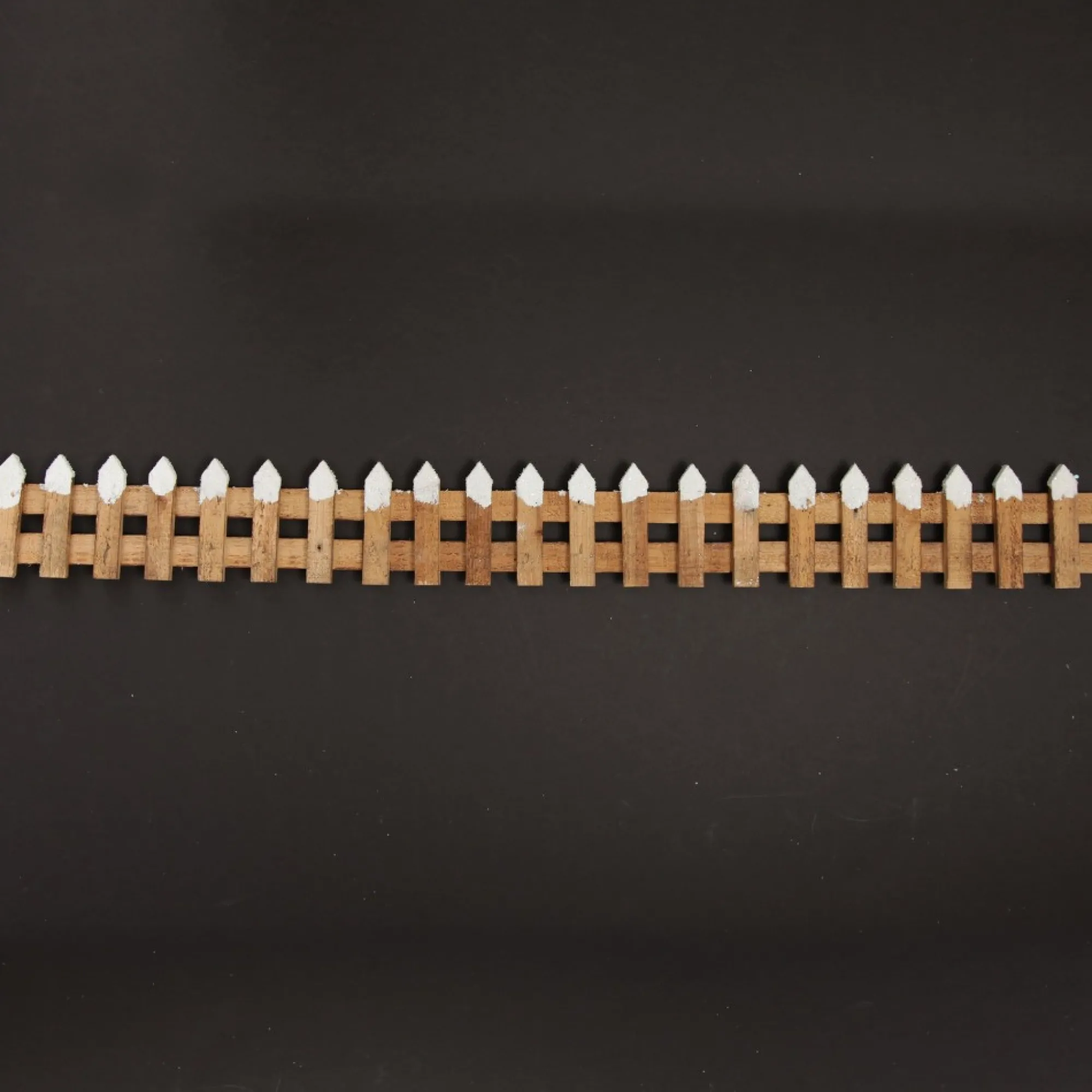 Short Snow Capped Natural Wooden Picket Fence Store