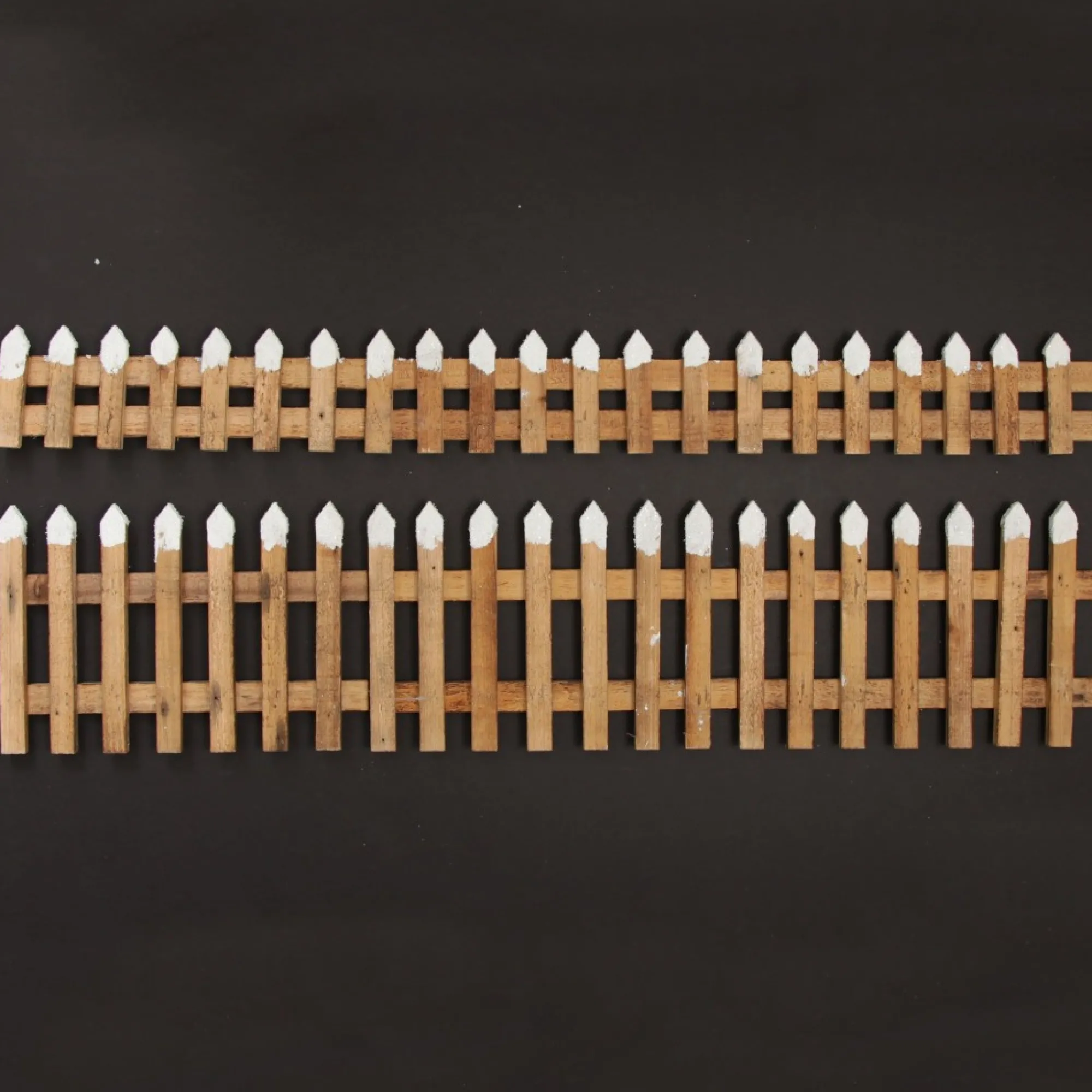 Short Snow Capped Natural Wooden Picket Fence Store